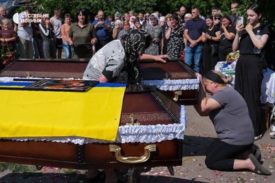 The aunt of the Moseychuk brothers and Roman's wife Olga say goodbye to their relatives in the yard of the two-story house in Kalynivka, where Maksym lived with his mother