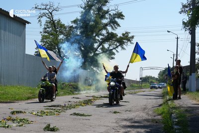 Young people on motorcycles accompany cars carrying the bodies of the murdered Maksym and Roman Moseychuk from the morgue to their home on the day of farewell in Kalynivka. Kyiv region, July 15, 2026