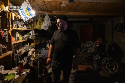 Serhiy Moseychuk, the younger brother of the murdered Roman and Maksym Moseychuk, shows the garage at the family dacha in Kalynivka. Kyiv region, July 13, 2026