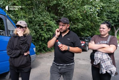 Serhiy Moseychuk with his wife and a friend of the Moseychuk family, Olga Metelska (right), in Kyiv near the morgue for identification, July 13, 2026