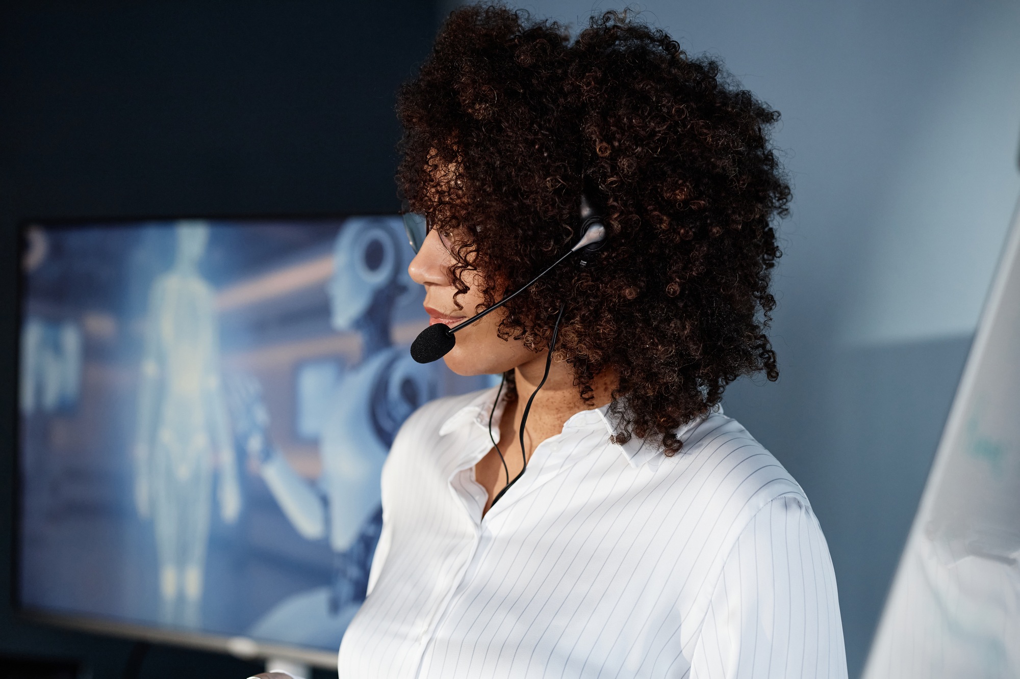 Black Female Speaker Wearing Mic Presenting AI Technologies at Business Forum