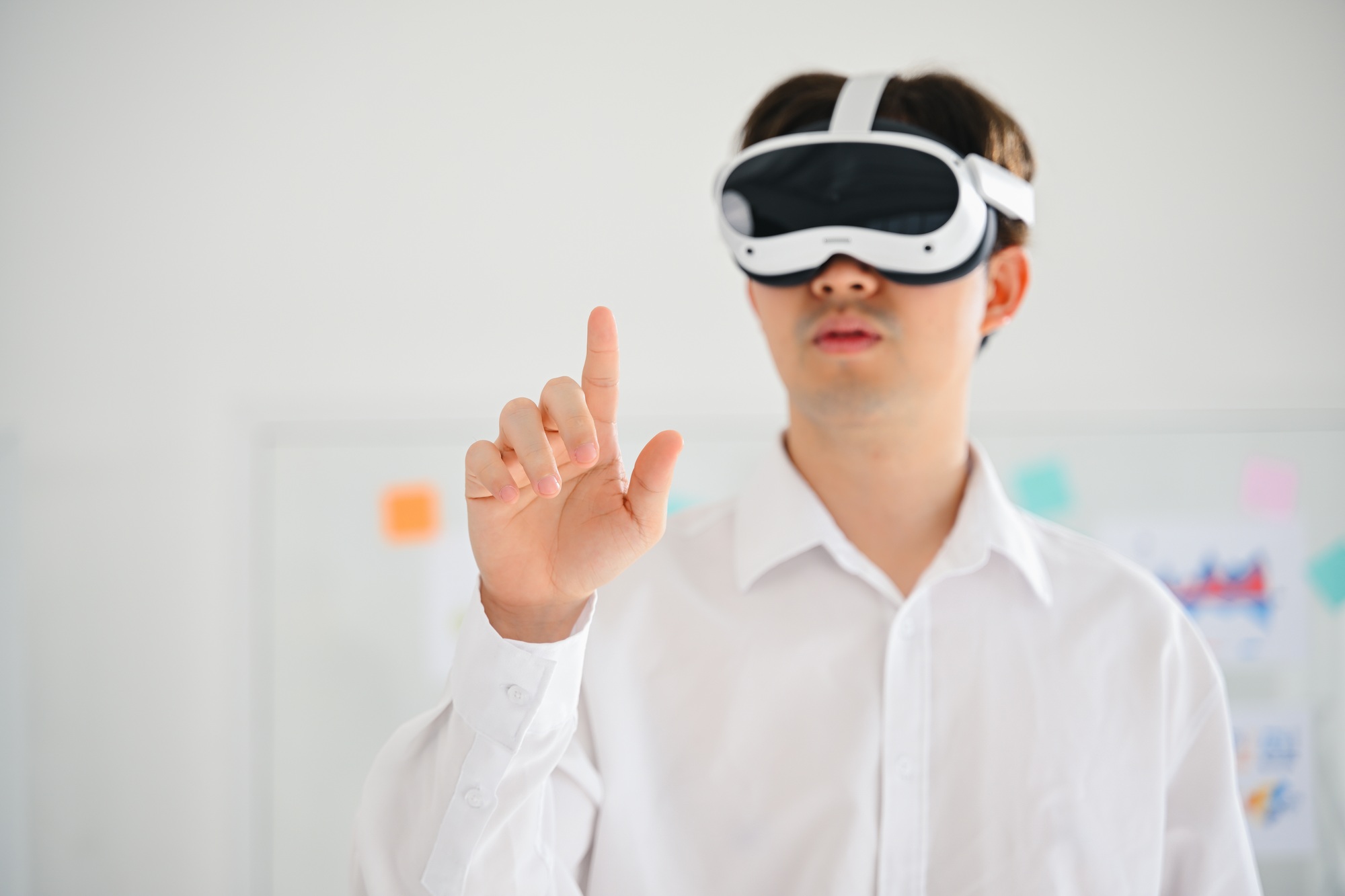 Businessman wearing virtual reality goggles headset and touching AI world, Happy man touching